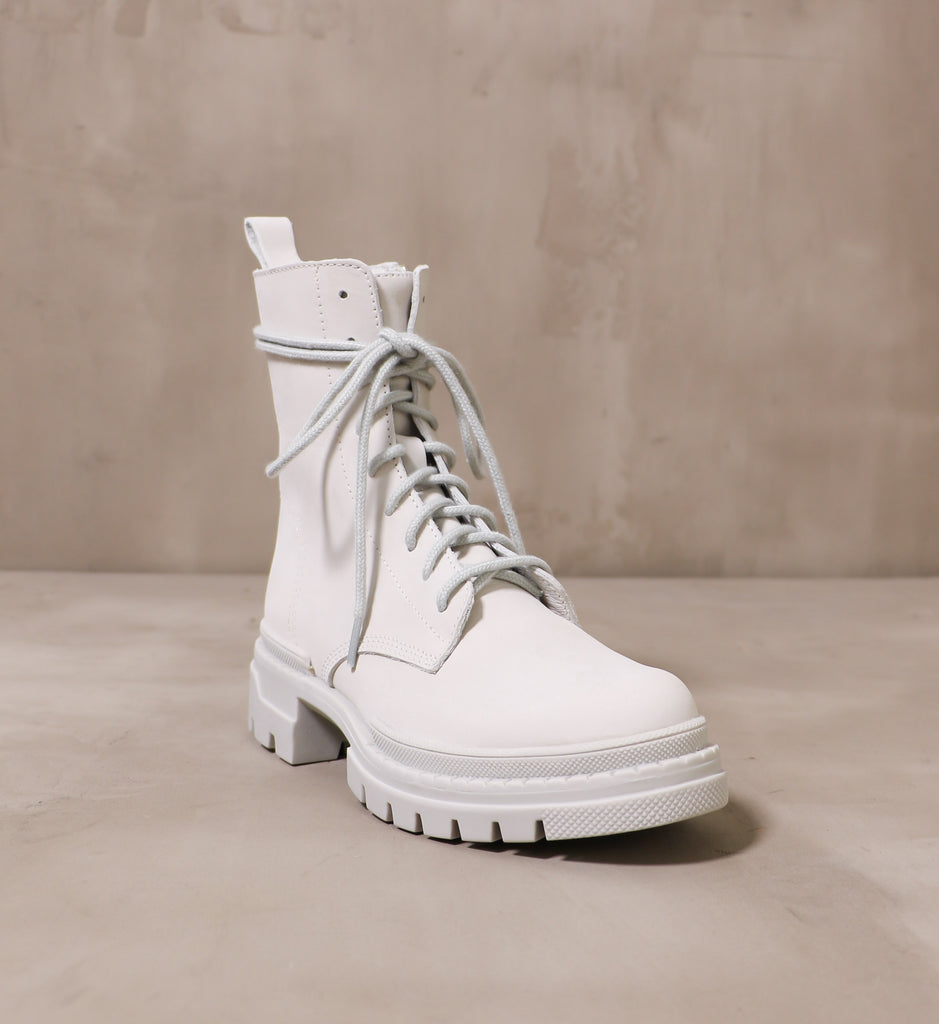 front of the open toe leather light grey clean slate boot angled on cement background
