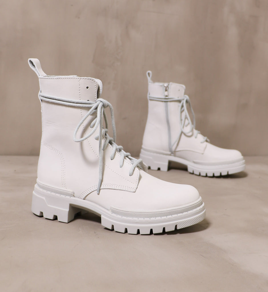 light grey clean slate boots angled on cement background