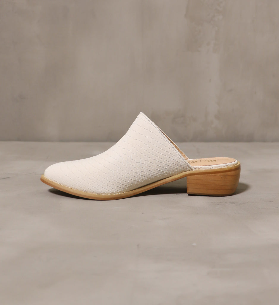 inner side of the cream of the croc slip on mule with tan insole and brown stacked wood heel