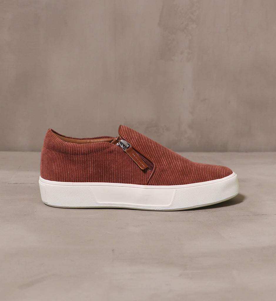 outer side of the tan corduroy meets world sneaker with side zipper pull detail
