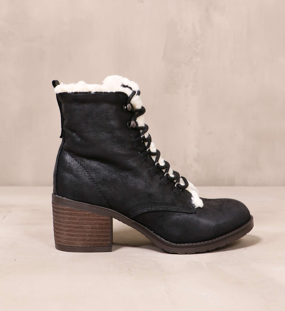 outer side of the distressed leather upper and cream sherpa trim on the don't get cold feet booties