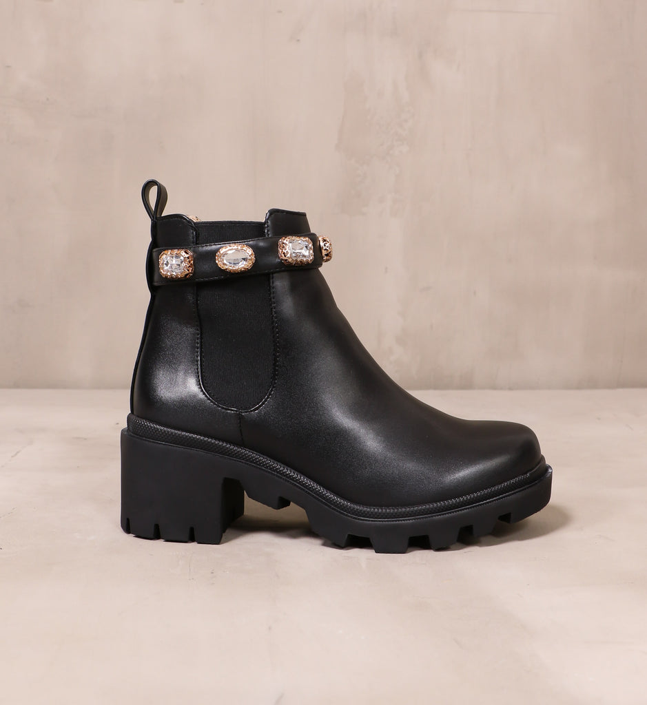 outer side of the drip'in diamonds black boot with crystal detail on the top of the boot
