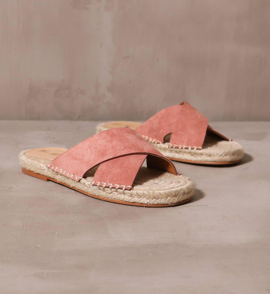 a pair of rose blush pink espadrille you go with me slides on cement background