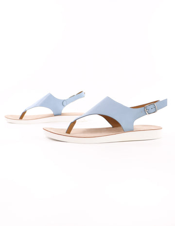 close up of the blue walk with me sandal with white bottom on solid background - elle bleu shoes