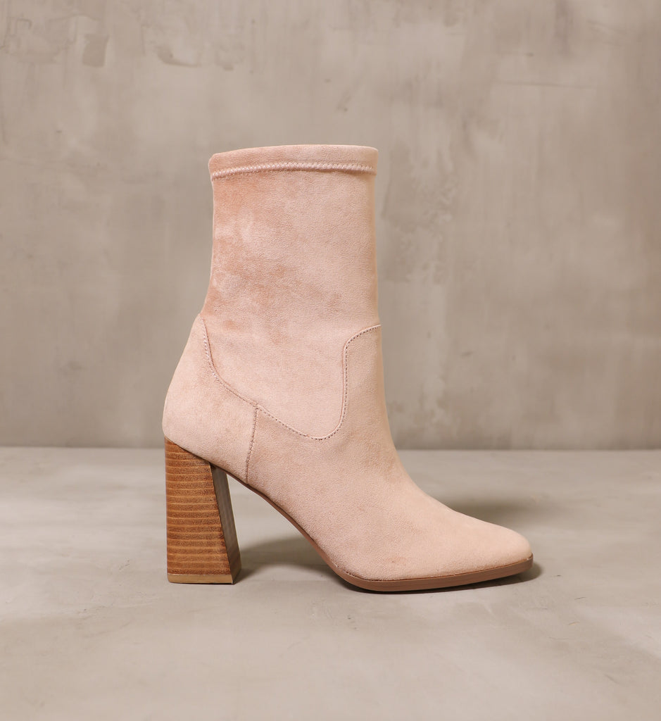 outer side of the forget yesterday bootie with blush tan suede upper and angled stacked wood block heel