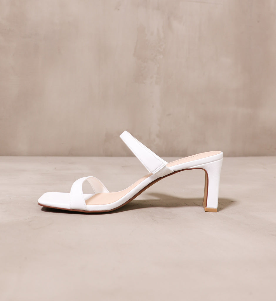 inner side of the thin white straps on the french manicure heel