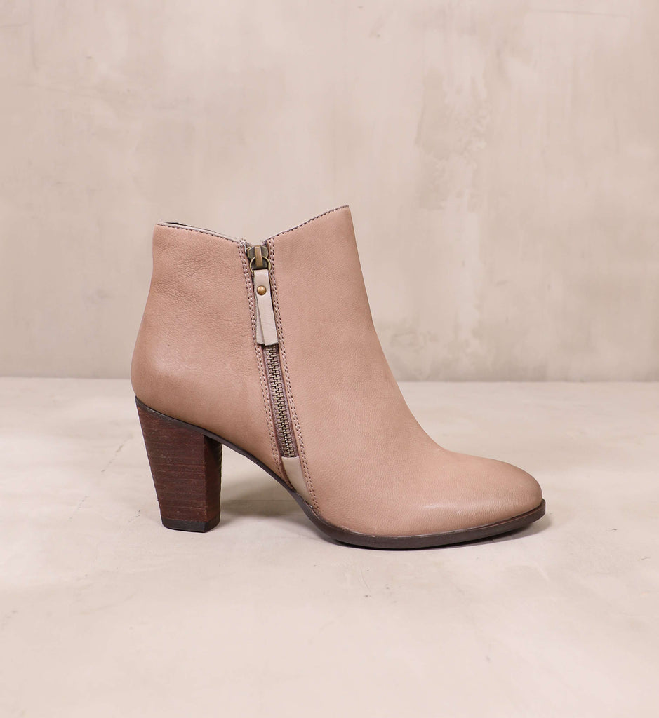 outer side of the heart zips a beat bootie with side zipper detail and block wood heel