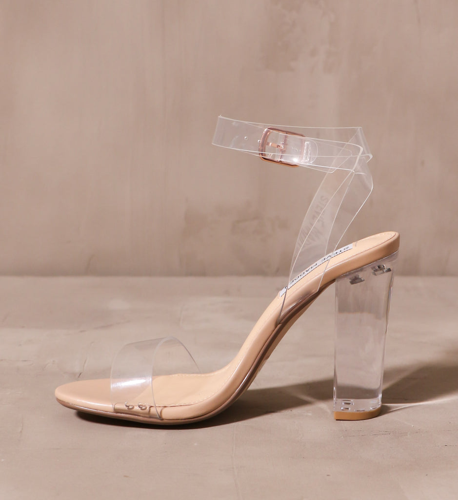 inner side of the home before midnight heel with tan insole and clear straps and block heel