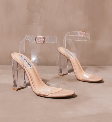 home before midnight heel with clear ankle and bridge straps with clear block heel on cement background