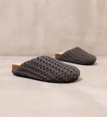 grey in the knit of time slip on clogs angled on cement background