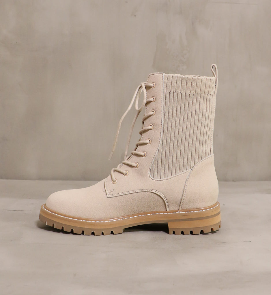 inner side of the taupe kickin' knit boot on cement background