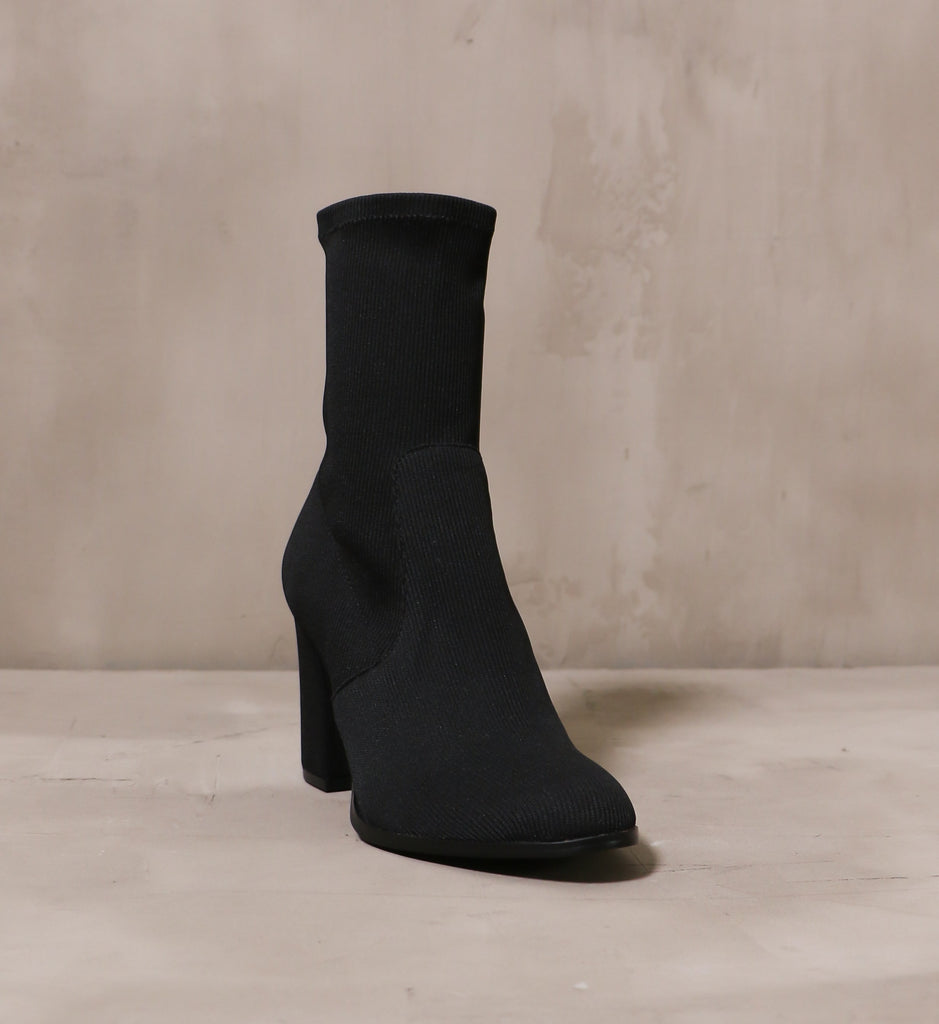 round toe detail and block heel on the ribbed knit happens bootie