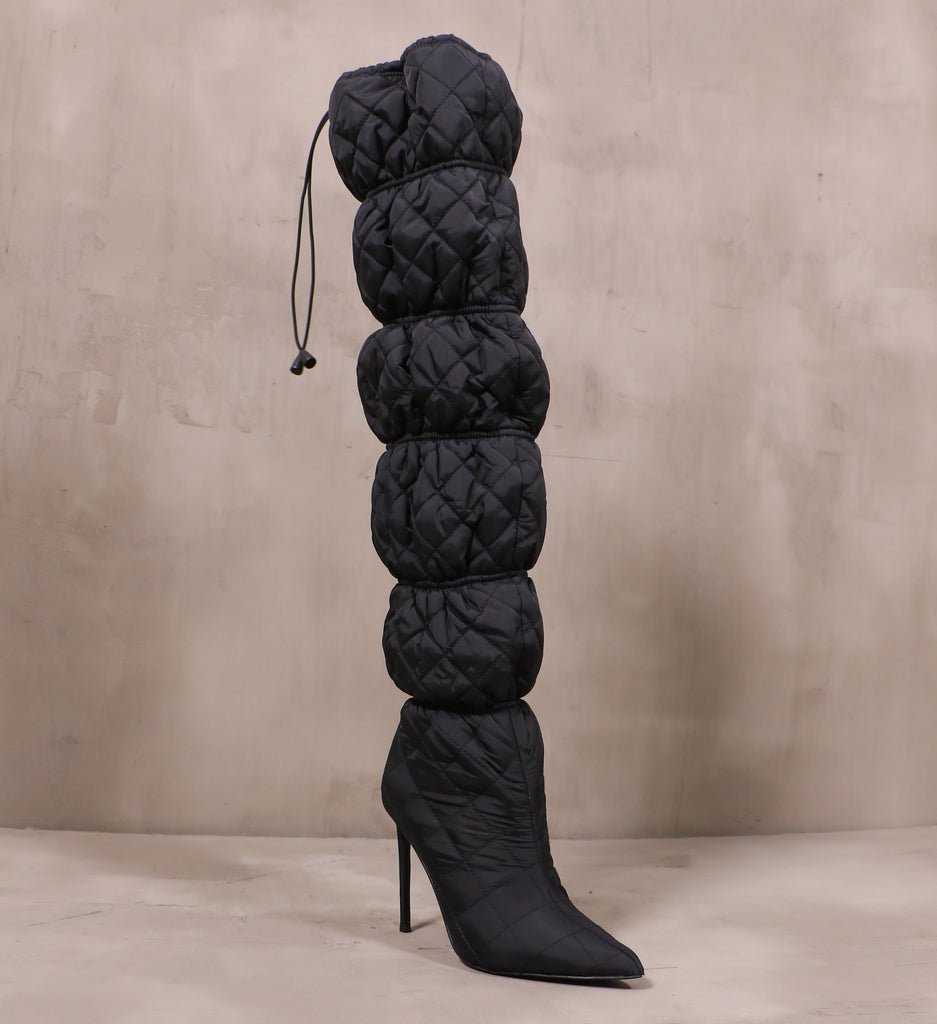 front of the pointed toe and banded fabric quilted upper on the mother puffer boots
