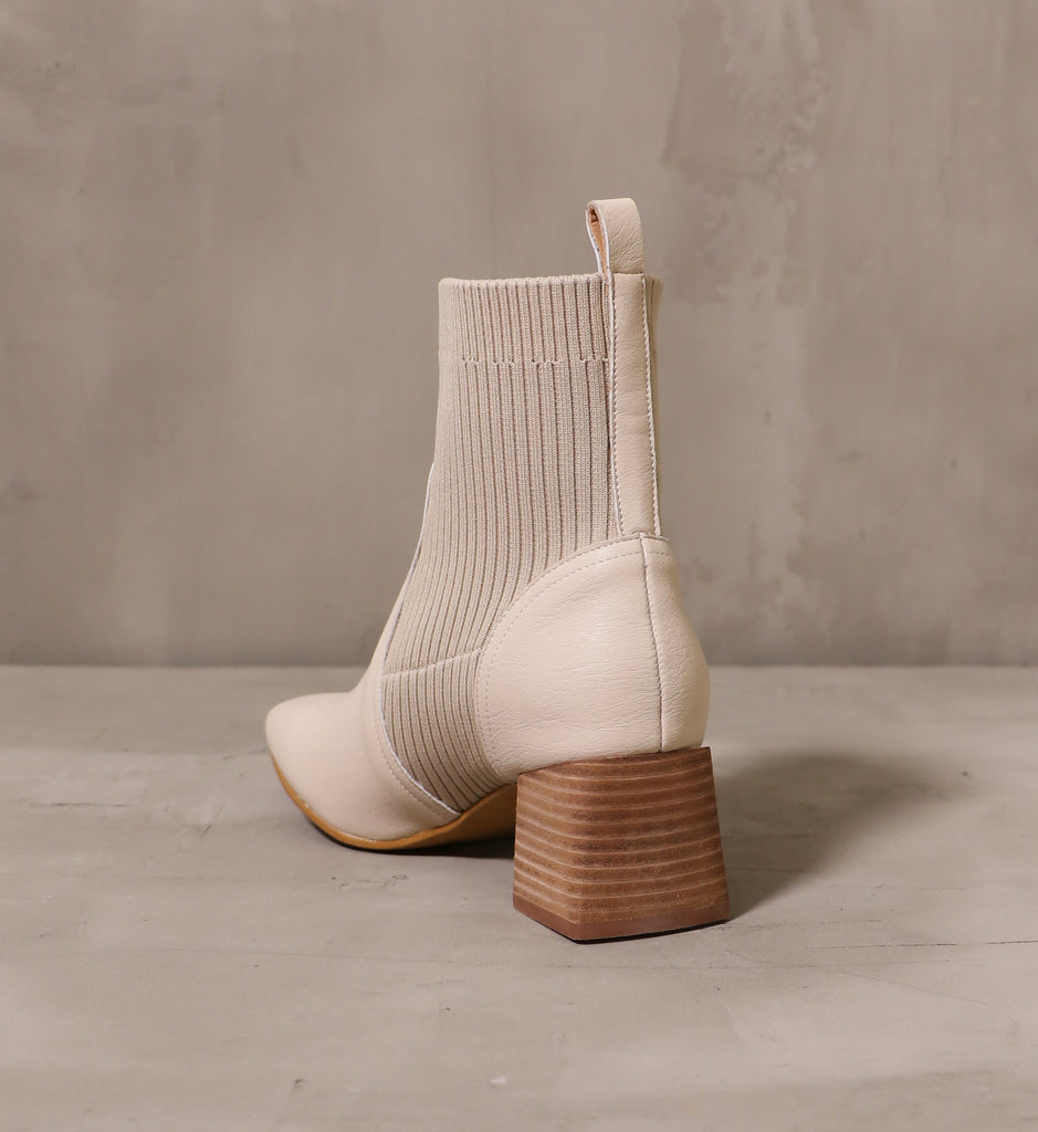 back of the stacked wood block heel and beige leather and knit upper