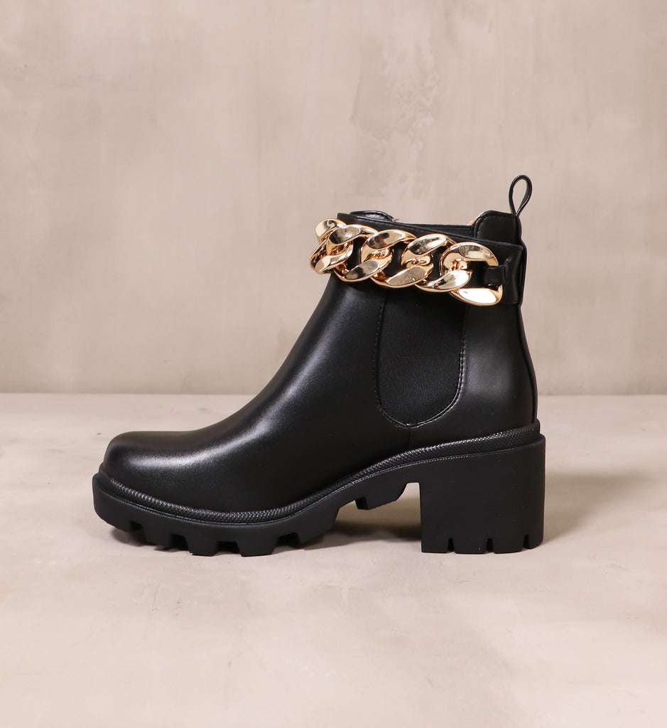 inner side of the off the chain boot with elastic panel and gold chain detail at the top