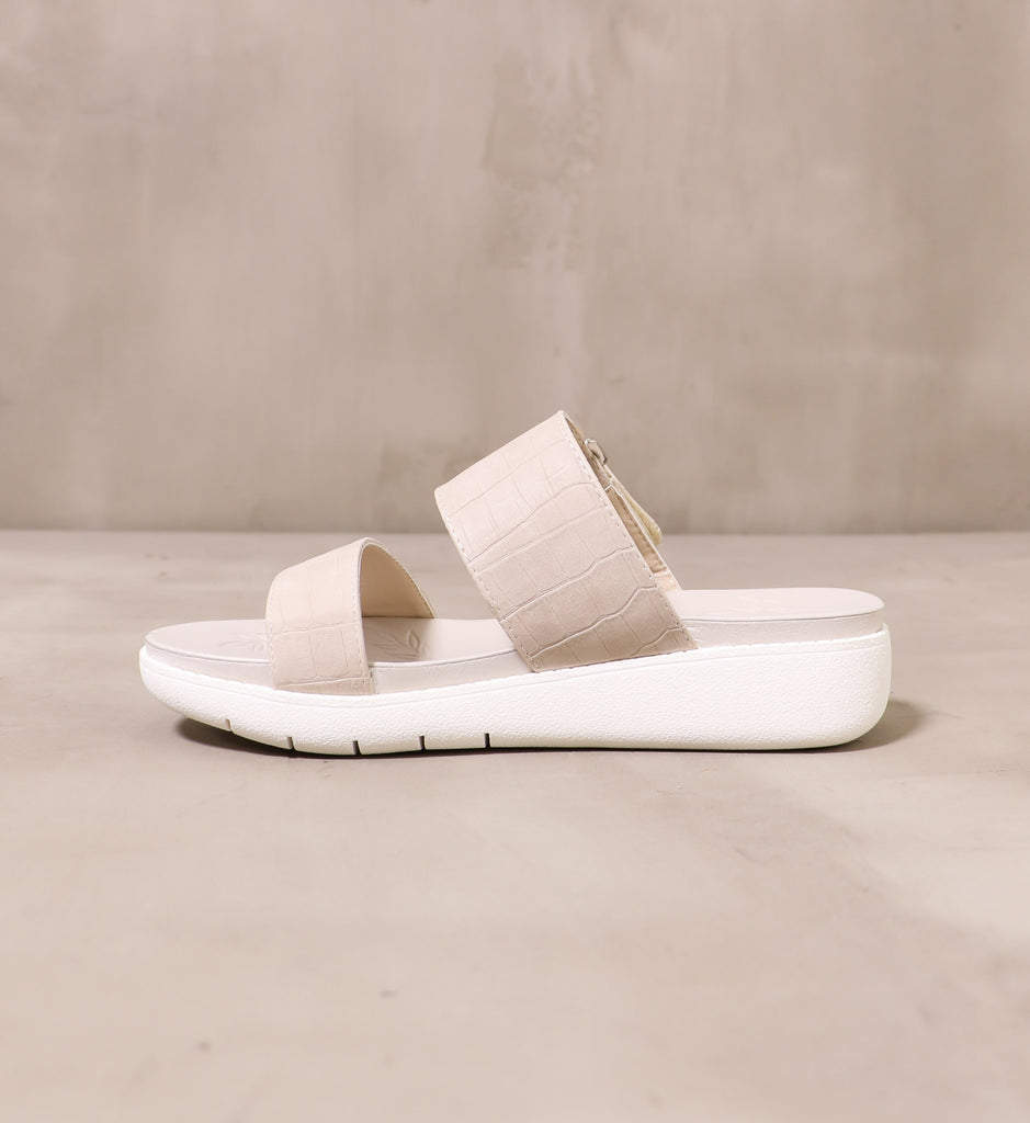 inner side of off white vegan leather straps on the one two strap sandal