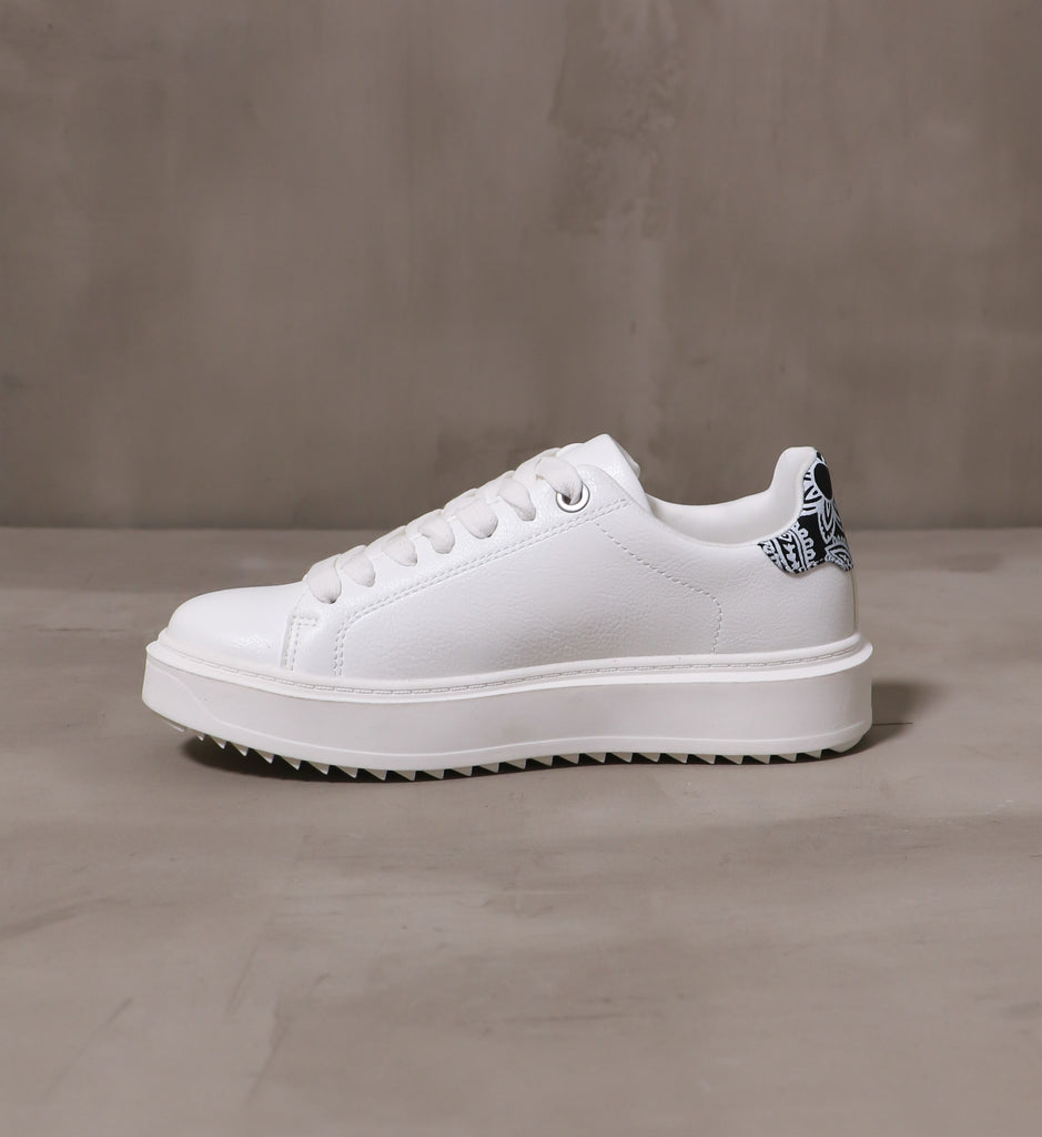 inner side of the white pais-lead the way sneaker with white laces and rubber sole