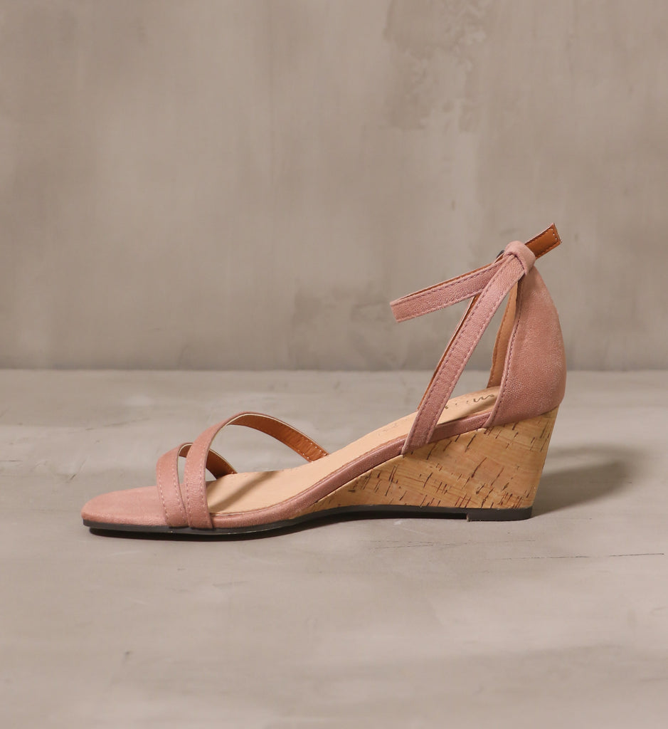inner side of the rose pink thin straps on the cork sole of the pastel me you love me wedge