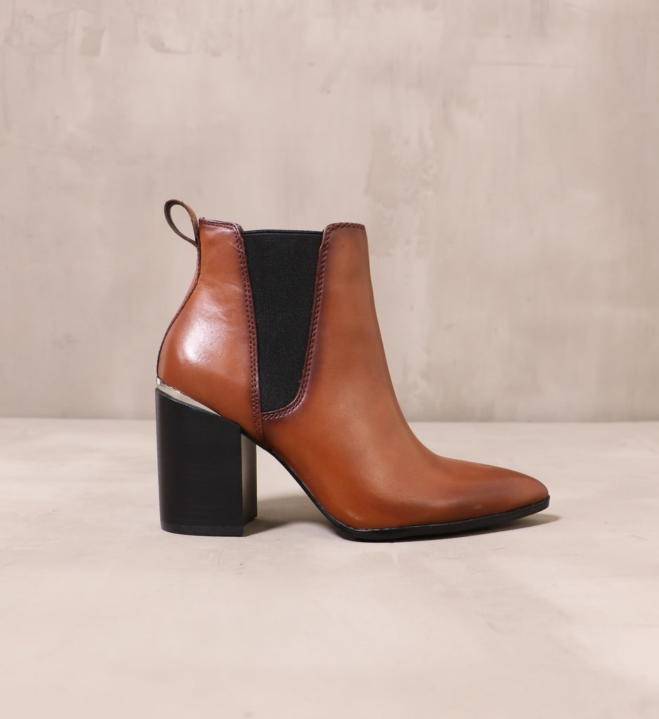 outer side of the cognac oil rubber leather upper and black elastic trim panel on the perfectly trimmed ankle boot