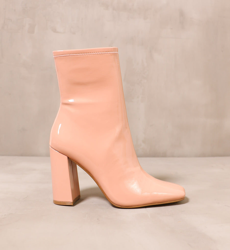 outer side of the pink big boot with leather wrapped block heel and shiny upper