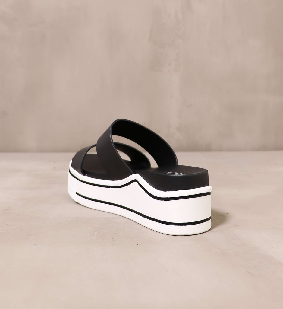 back of the platform an opinion sandal with chunky white rubber sole with black stripe details