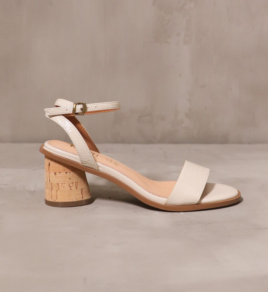 outer side of the beige pop the cork heel with thin ankle strap and open toe