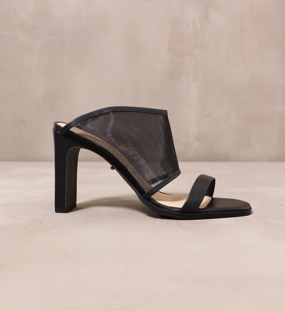 outer side of the seven sheer itch heel with black leather wrapped sole and strap