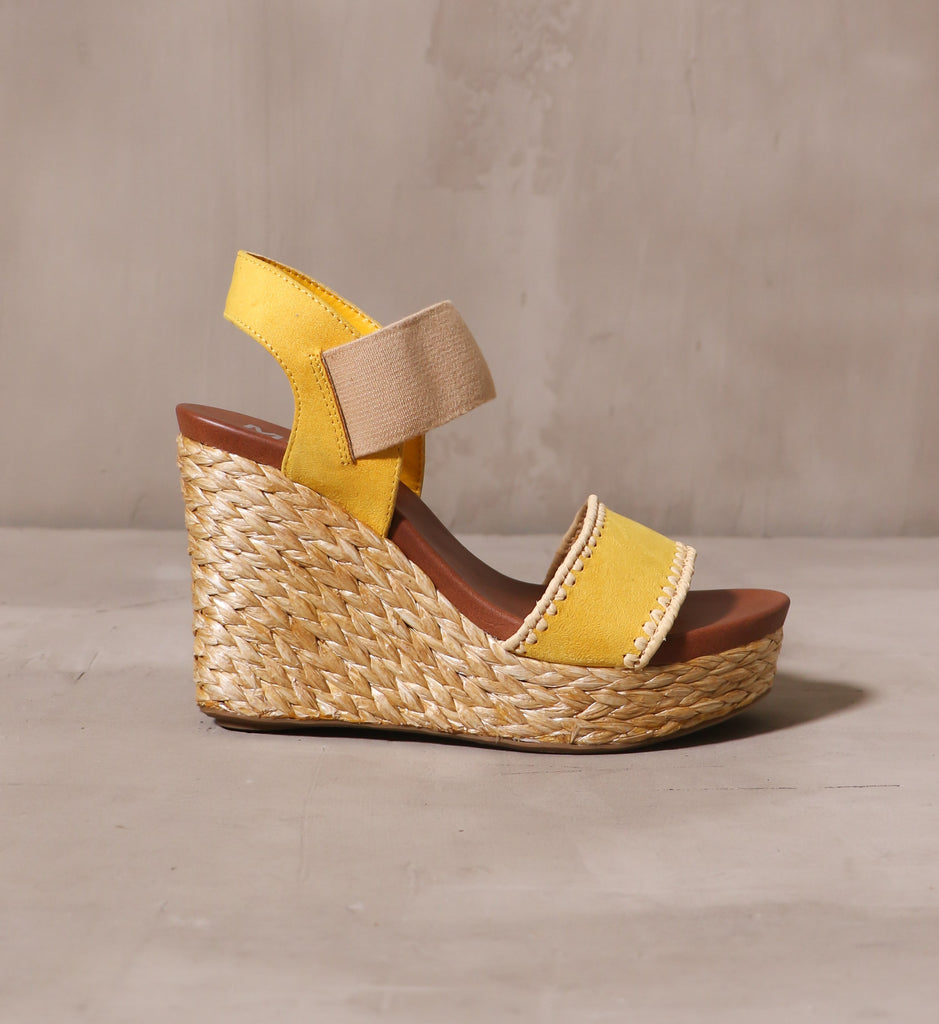 outer side of the mustard yellow shore thing wedge with brown leather insole and rope wrapped sole