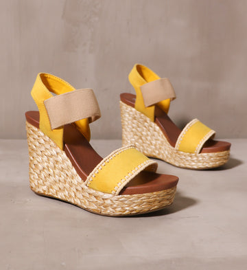 a pair of mustard yellow shore thing wedge with braided rope wrapped sole and brown leather insole
