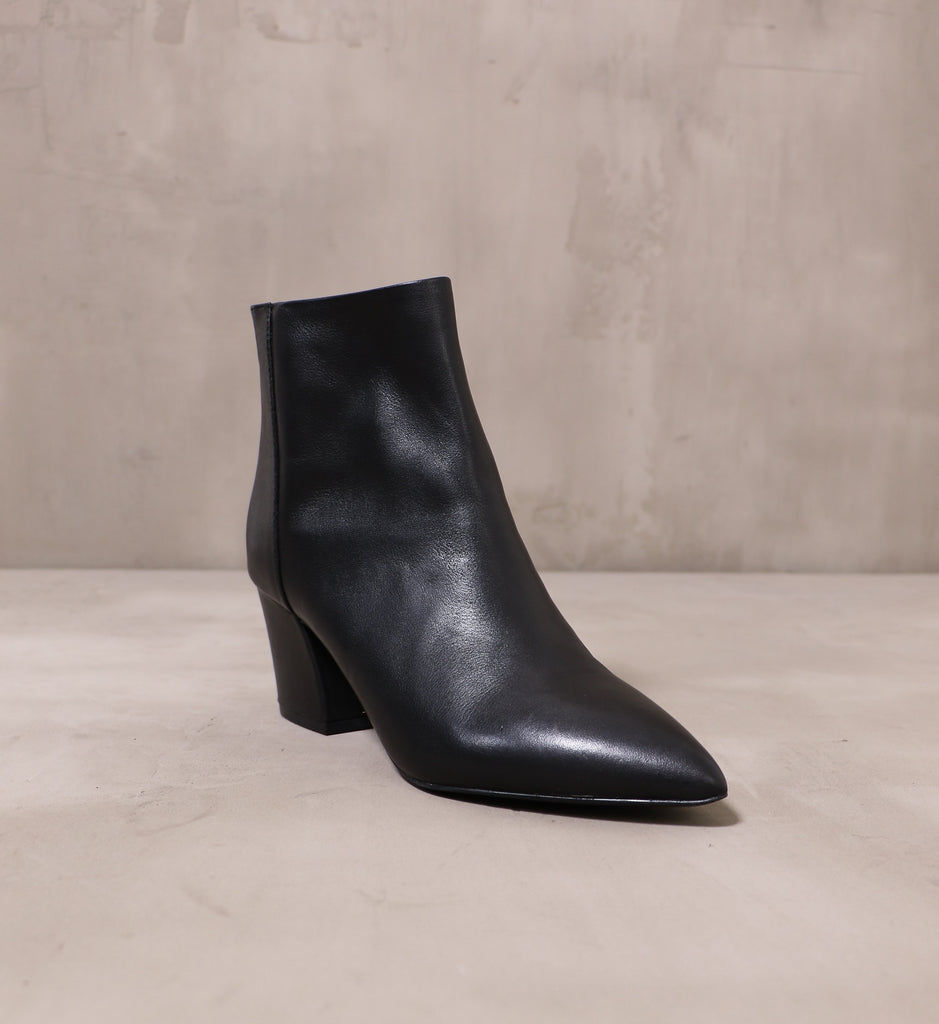 front of the pointed toe simple explanation boot with leather black upper
