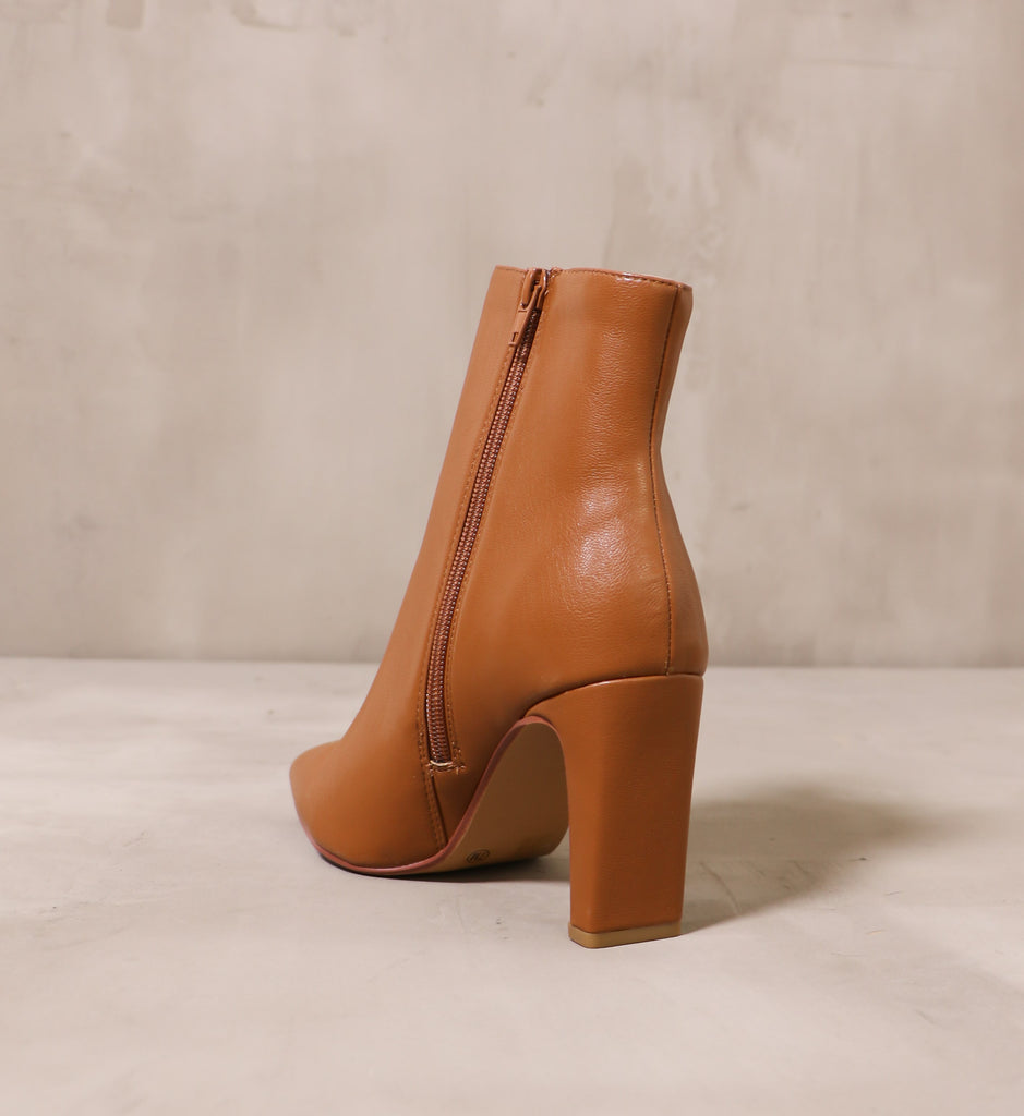 back of the rectangle block heel on the sleek step tan brown ankle boot