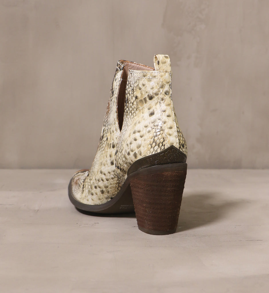 back of the snake my day ankle bootie with dark brown stacked wood heel and metal embossed heel detail