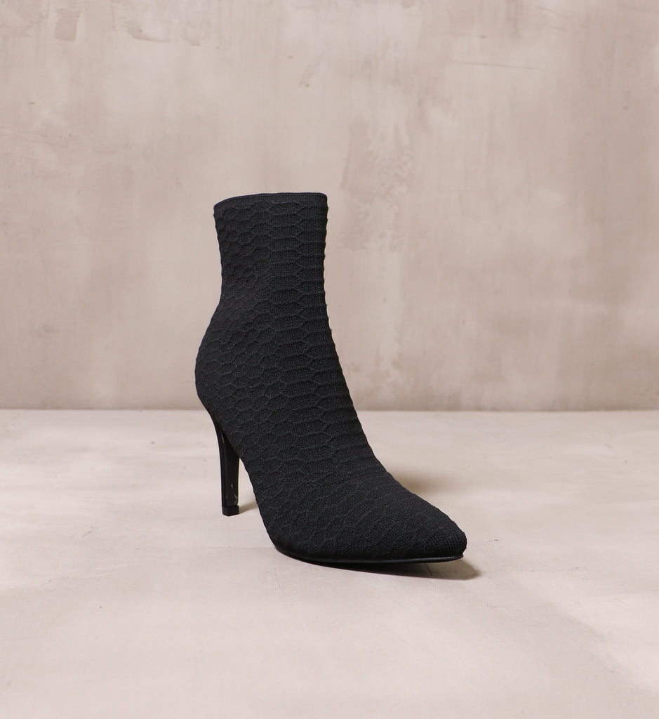 front of the textured pointed toe fabric upper on the black sock it to me bootie