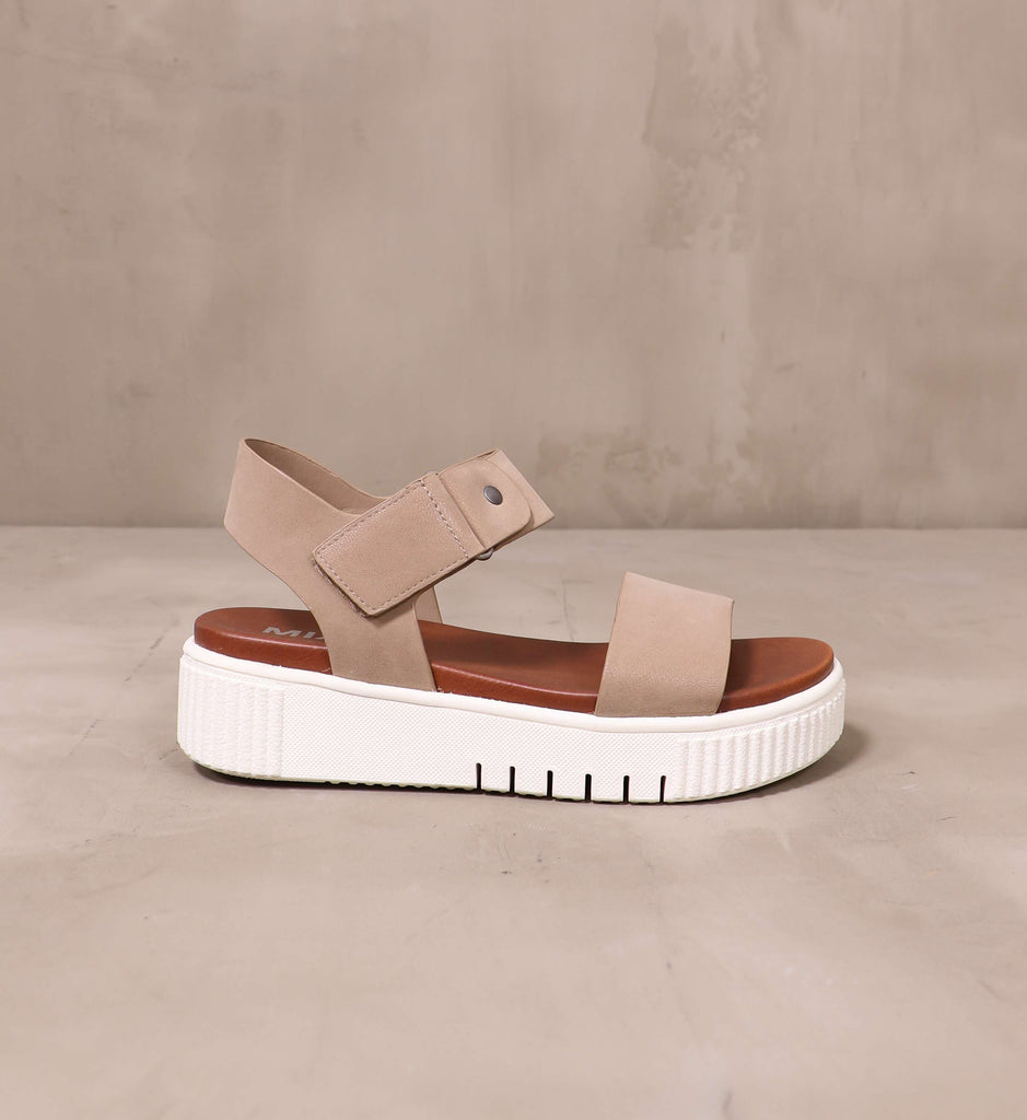 outer side of the taupe straps and brown insole on the sole mate platform sandal