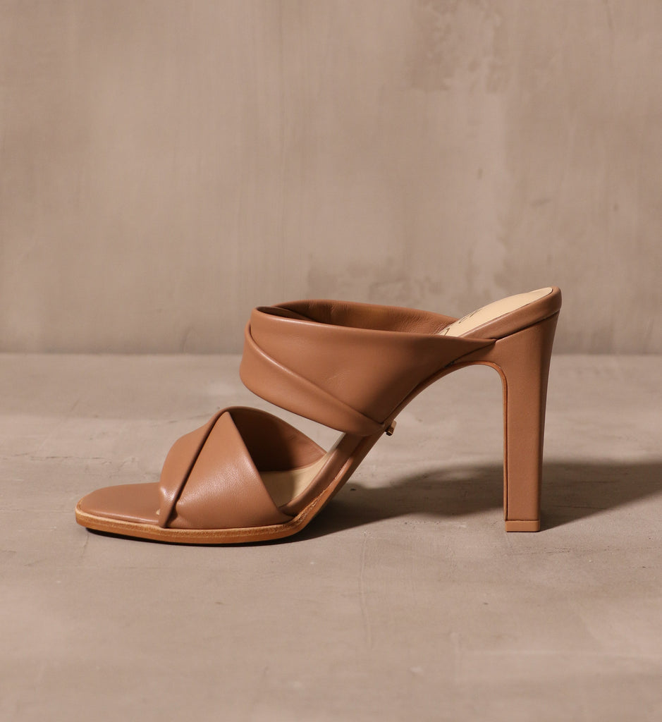 inner side of the tan state of luxe heel with folded leather straps across the bridge and vamp
