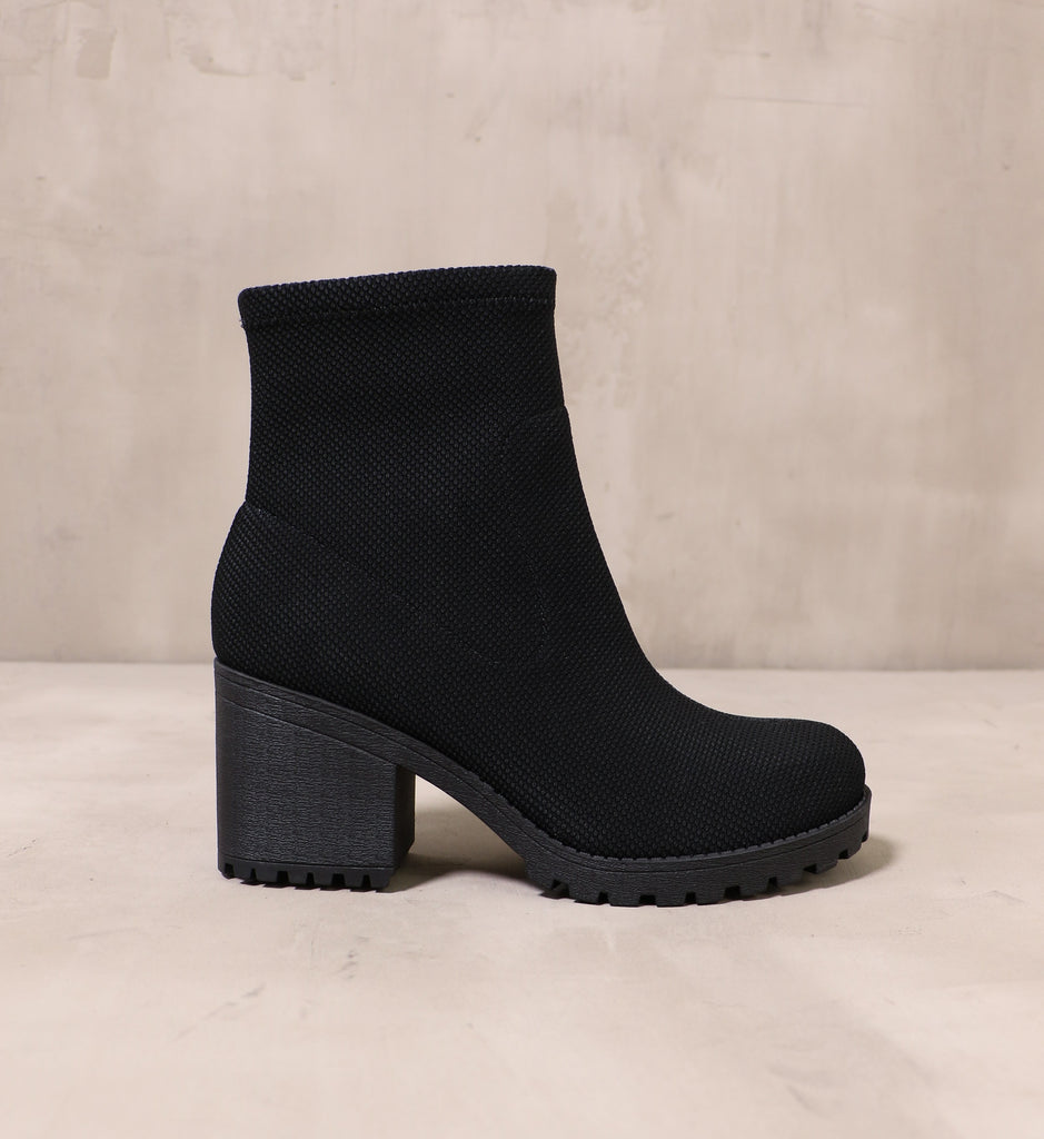outer side of the chunky rubber black lug sole and fabric upper on the stellar phenomena bootie