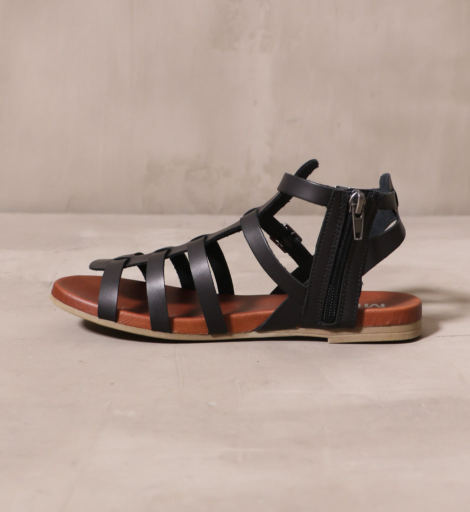 inner side of the black leather strappy makes me happy sandal with black zipper pull