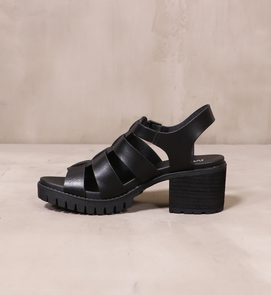 inner side of the all black strappy to cleat you sandal on cement background