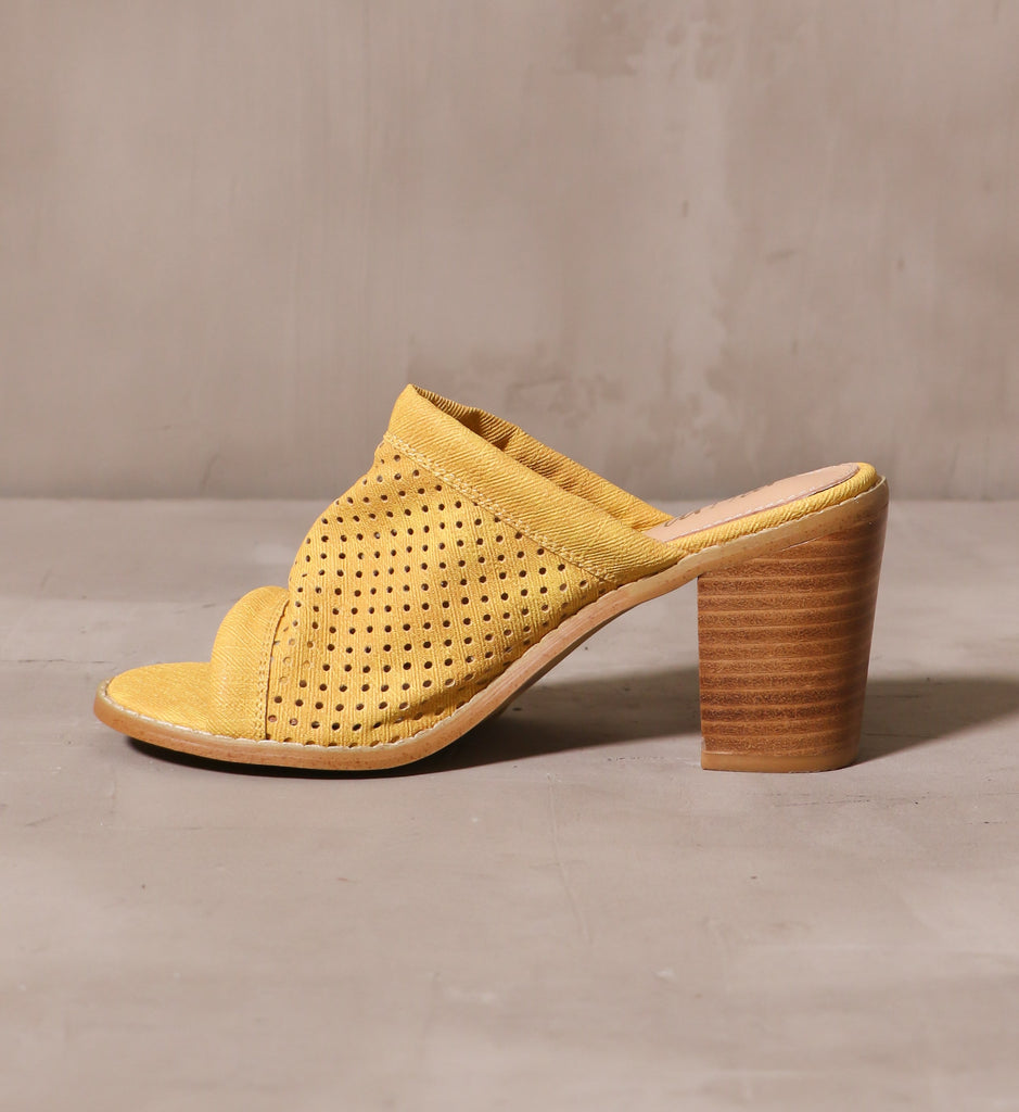 inner side of the yellow perforated canvas upper on the sunshine state of mind heel on cement background