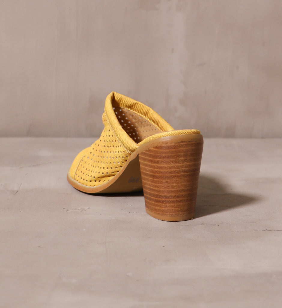 back of the stacked wood block heel of the sunshine state of mine yellow heel
