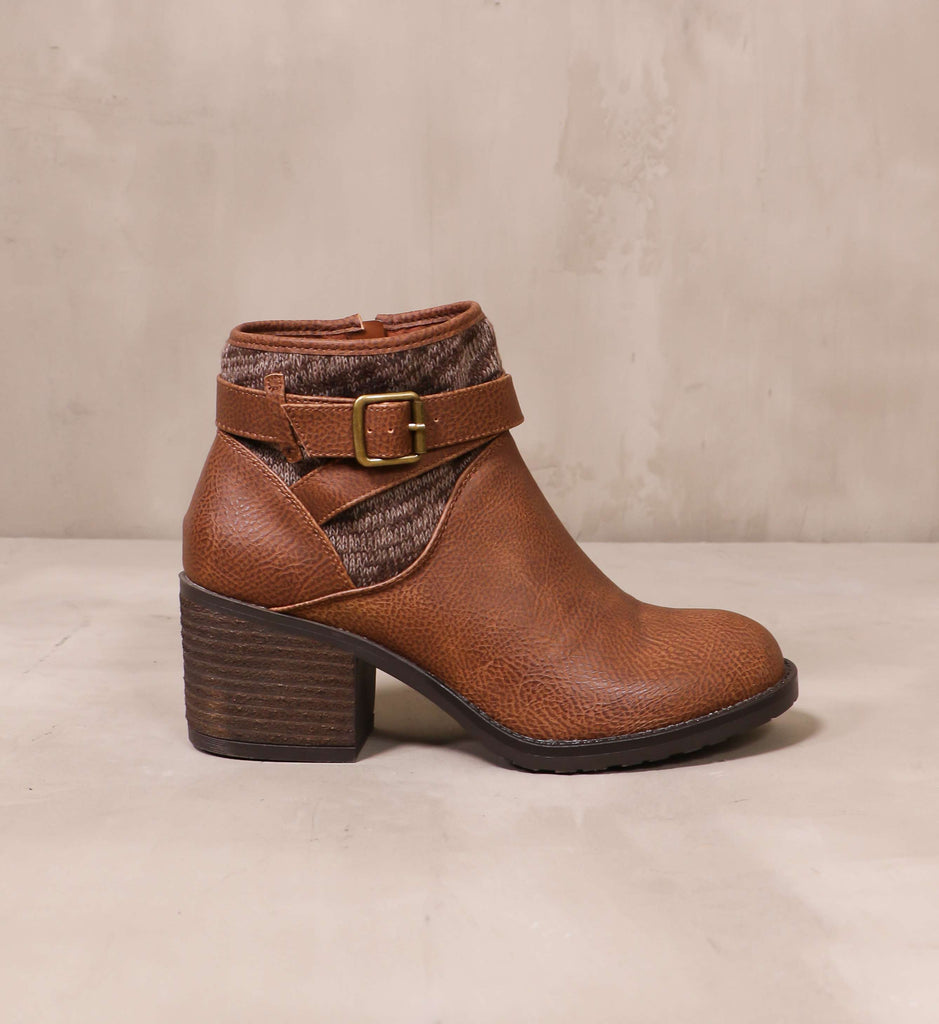 outer side of the brown sweater late than never ankle boot with bronze buckle detail on brown strap