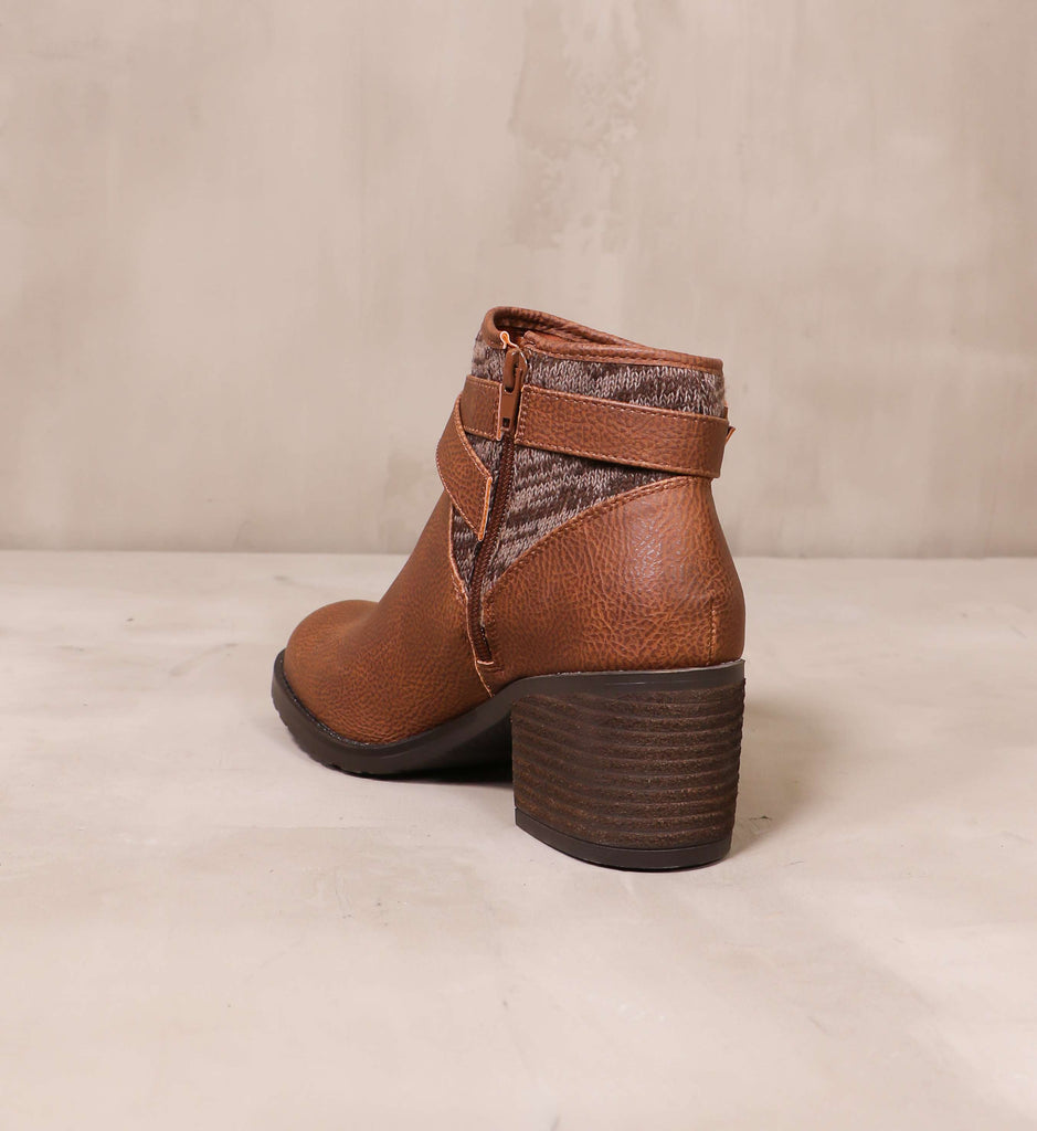 back of the stacked wood block heel on the brown sweater late than never ankle boot