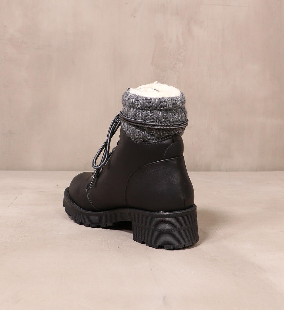 back of the sweater together black boot with chunky rubber lug sole