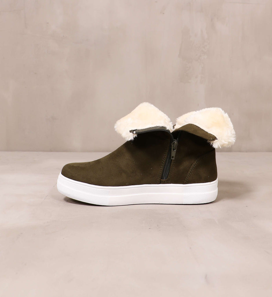 inner side of the sipper detail and cream fur trim on the olive take it outside convertible sneaker