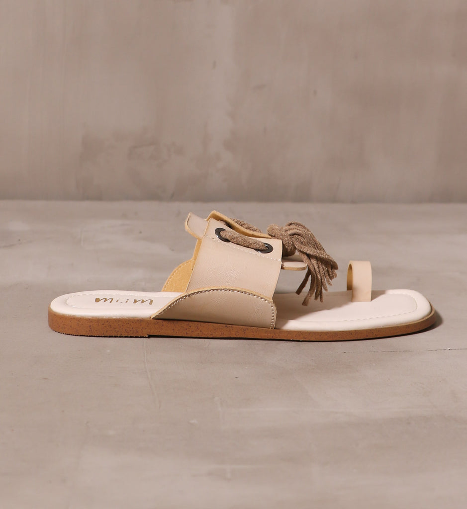 outer side of the tassel in the sky beige sole with off white insole on brown outsole