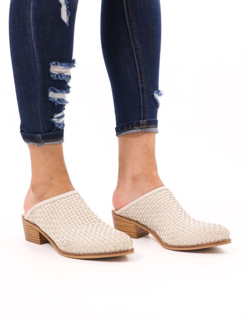 model standing in ice beige the woven one volatile mule and distressed denim - elle bleu shoes