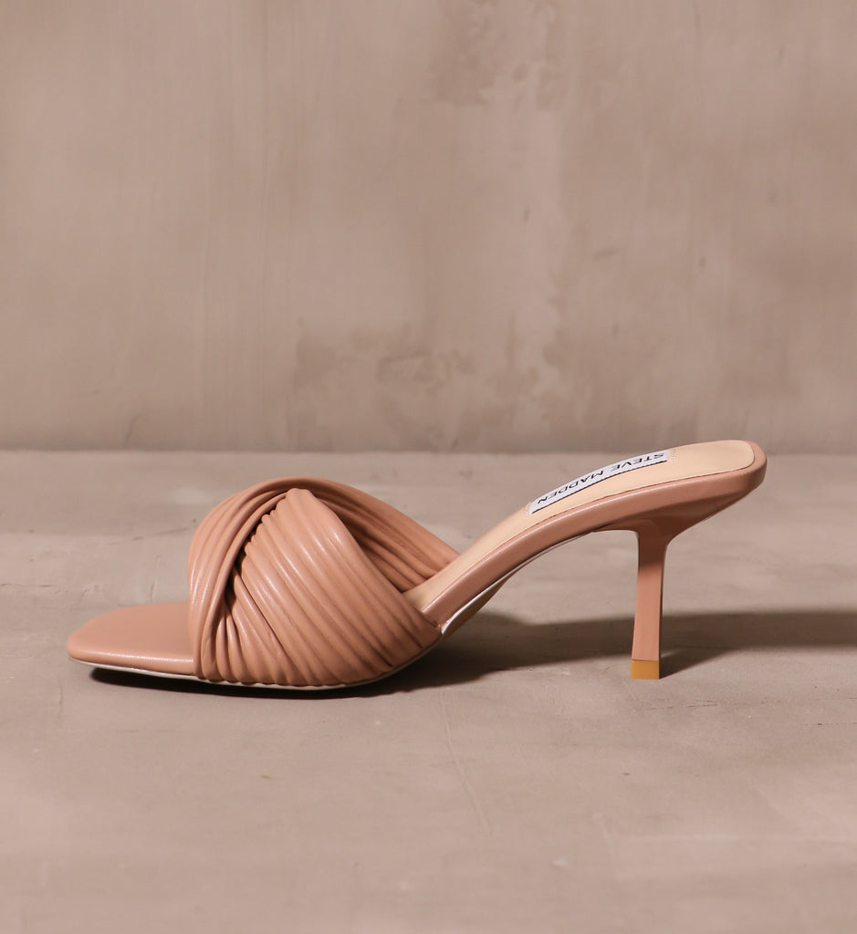 inner side of the tan twist of fate heel with curved stiletto heel and open square toe bed
