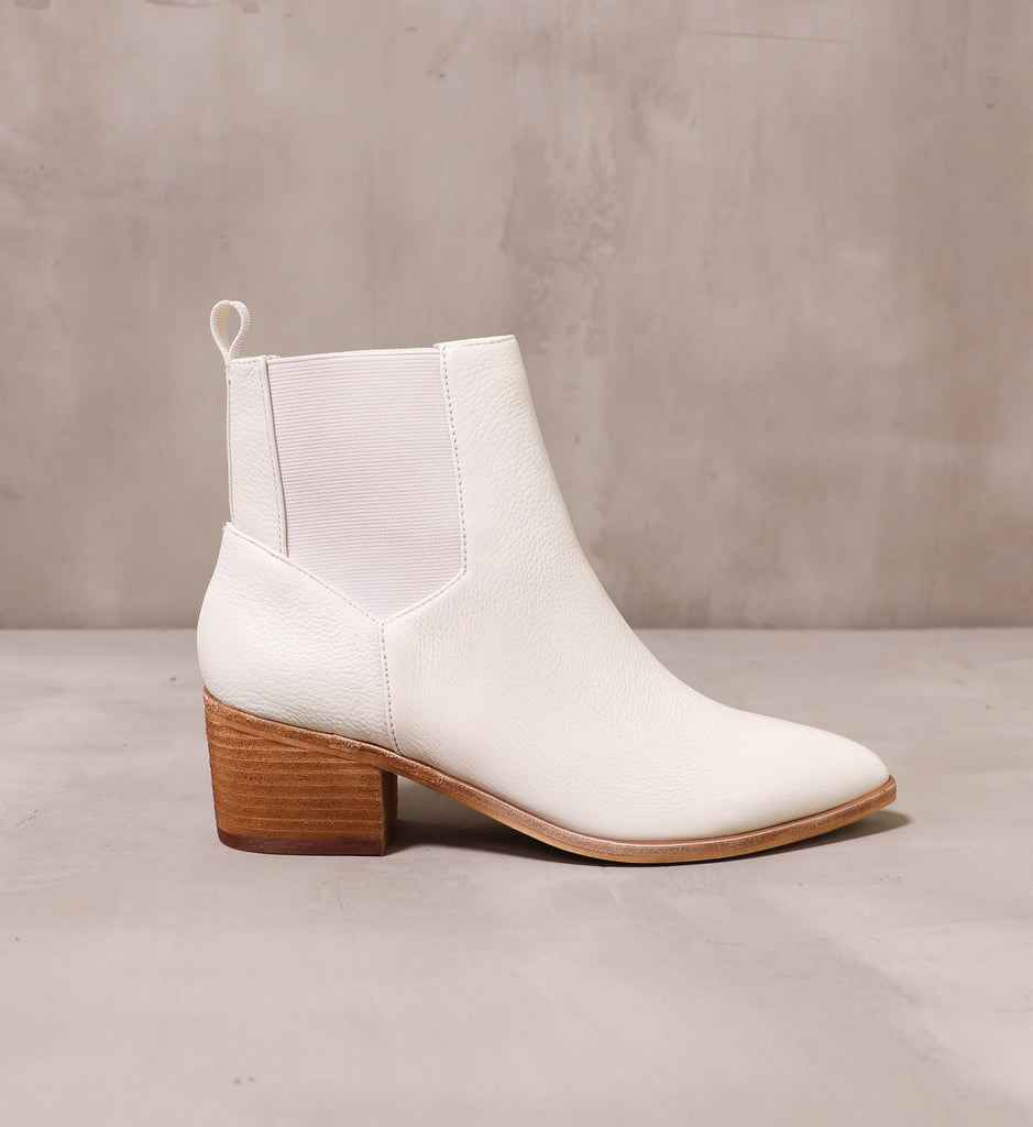 outer side of the off white urban street boot with stacked wood block heel on cement background