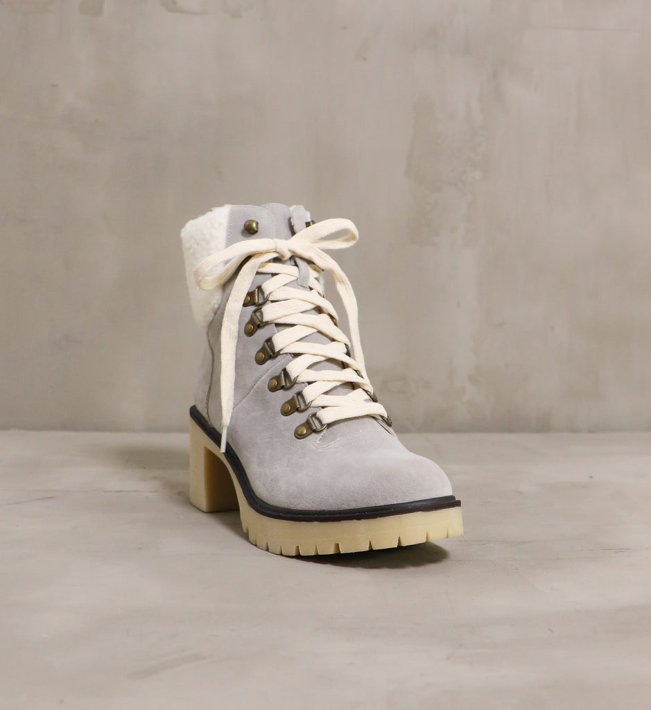front of the round toe warm sole boot with cream laces on top and chunky beige rubber lug sole