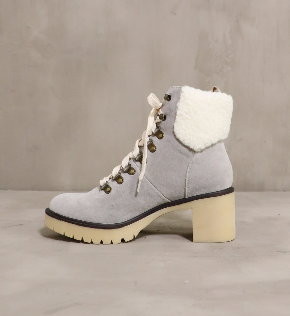 inner side of the warm sole boot with grey suede upper and faux sherpa detail on the top